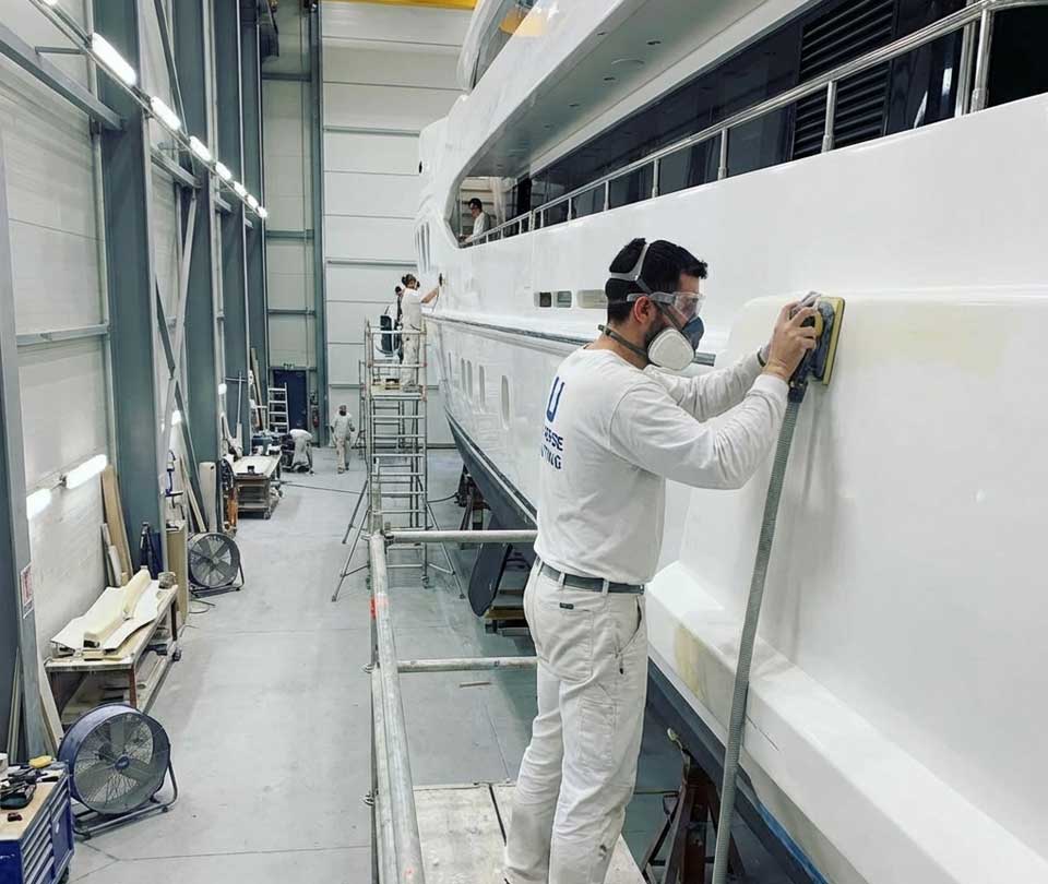 subcontractor painting a yacht for yachtwerft