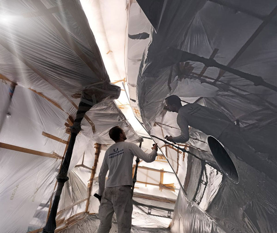painter inspecting high gloss superyacht paint