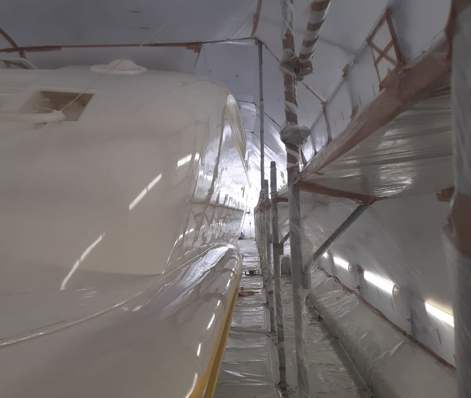 painter working in lusben shipyard refinishing Leopard yacht